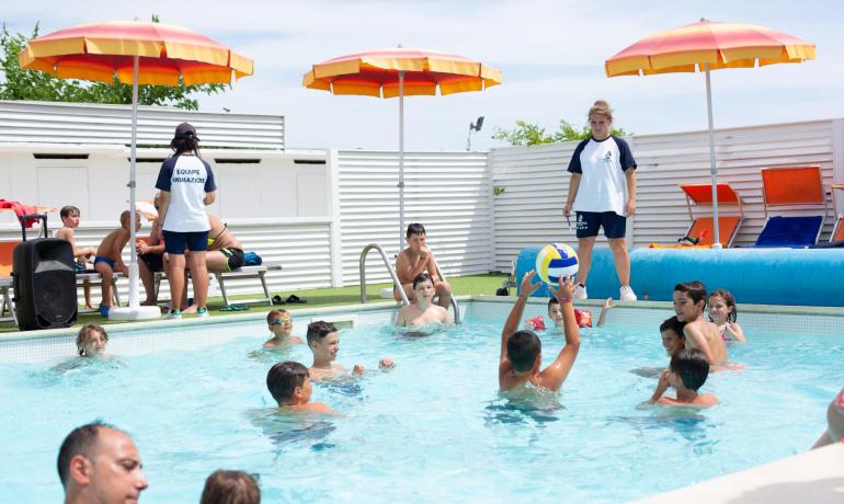 Children play in the pool under the supervision of animators.