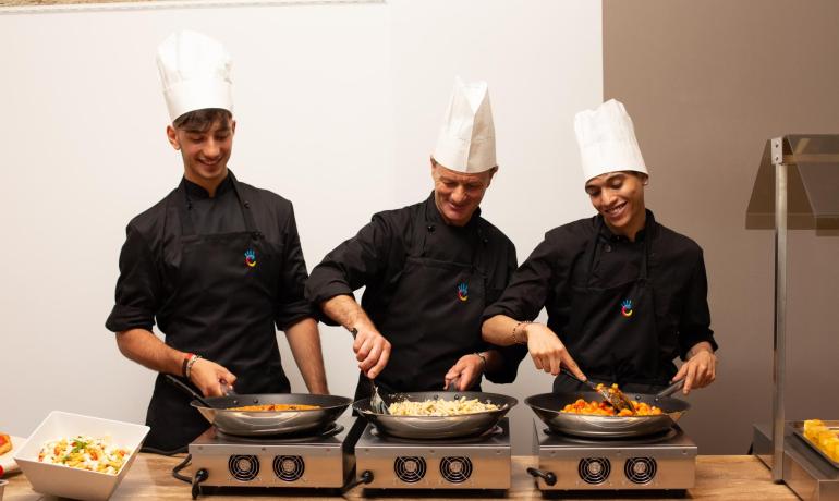 Three chefs cooking delicious dishes on stoves.