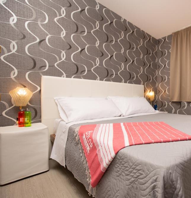 Cozy room with double bed, modern walls, and soft lighting.