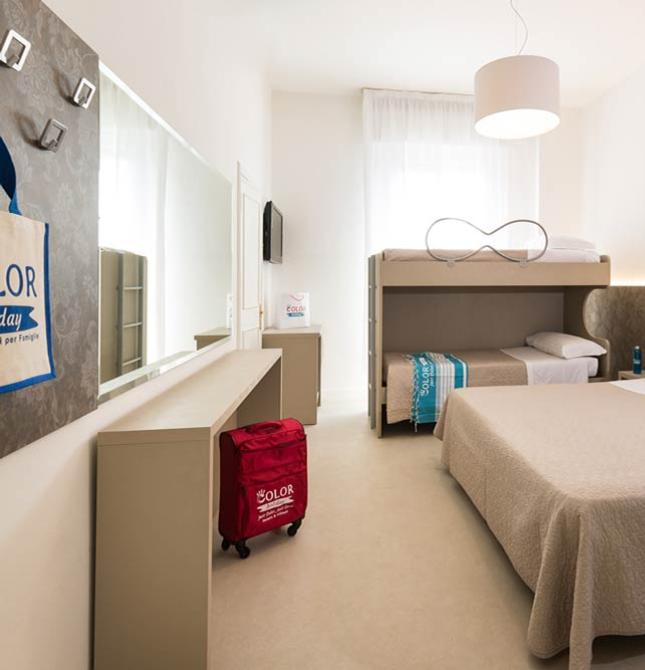 Cozy room with a double bed and bunk beds, warm and modern vibe.