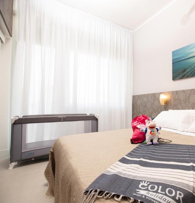 Cozy room with a double bed, warm lighting, and colorful toys.