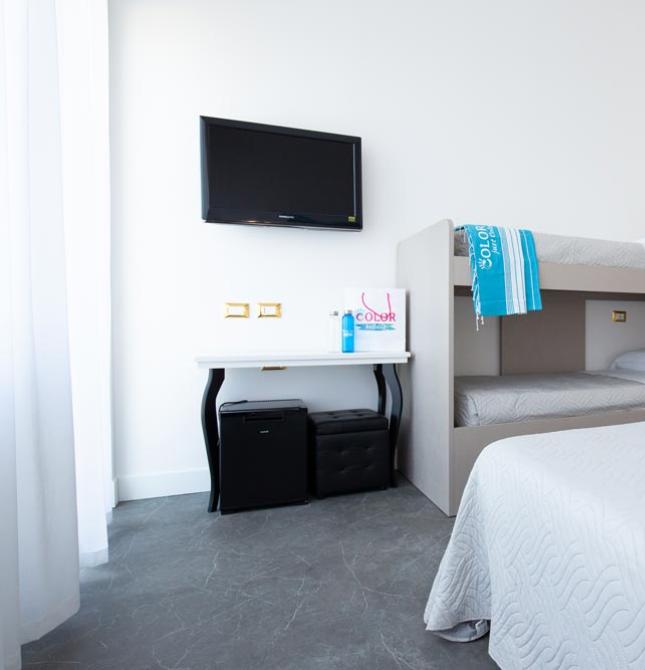 Bright, modern room with bunk beds and wall-mounted TV.
