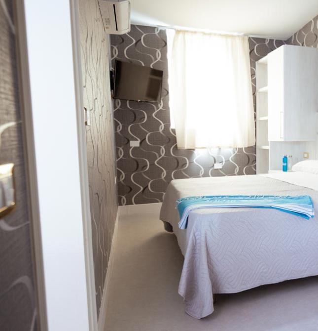 Modern, bright room with a double bed and light furnishings.